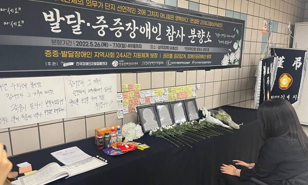 6월 14일 서울 용산구 삼각지역 앞에 전국장애인차별철폐연대와 전국장애인부모연대 등이 마련한 발달·중증장애인 참사 시민분향소에서 시민들이 헌화하고 고인들을 추모하고 있다.(사진=전국장애인차별철폐연대)